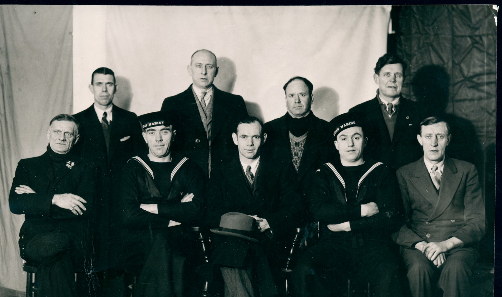 Survivors of the Emile Francqui, torpedoed in the Atlantic on 16 December 1942; of the eighty-seven aboard, fifty-two were lost. The two seated sailors wear the <i>Belgian Marine</i> cap tally: they are the ship’s gunners.